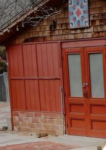 Close-up of the red barn's double doors and quilt square